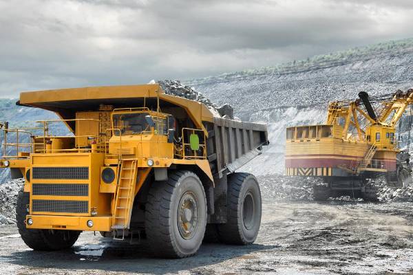 Heavy Mining Dump Truck Being Loaded With Iron Ore.